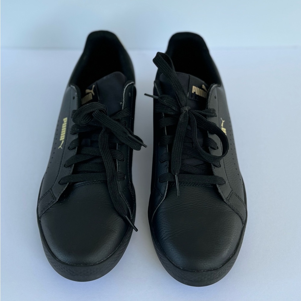 Puma shoes size 9.5 color black with gold in the back soft foam
